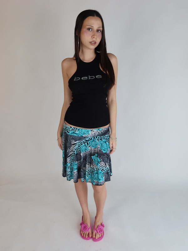 Y2K Bebe pink ribbed halter tank top featuring a rhinestone logo and fitted silhouette.