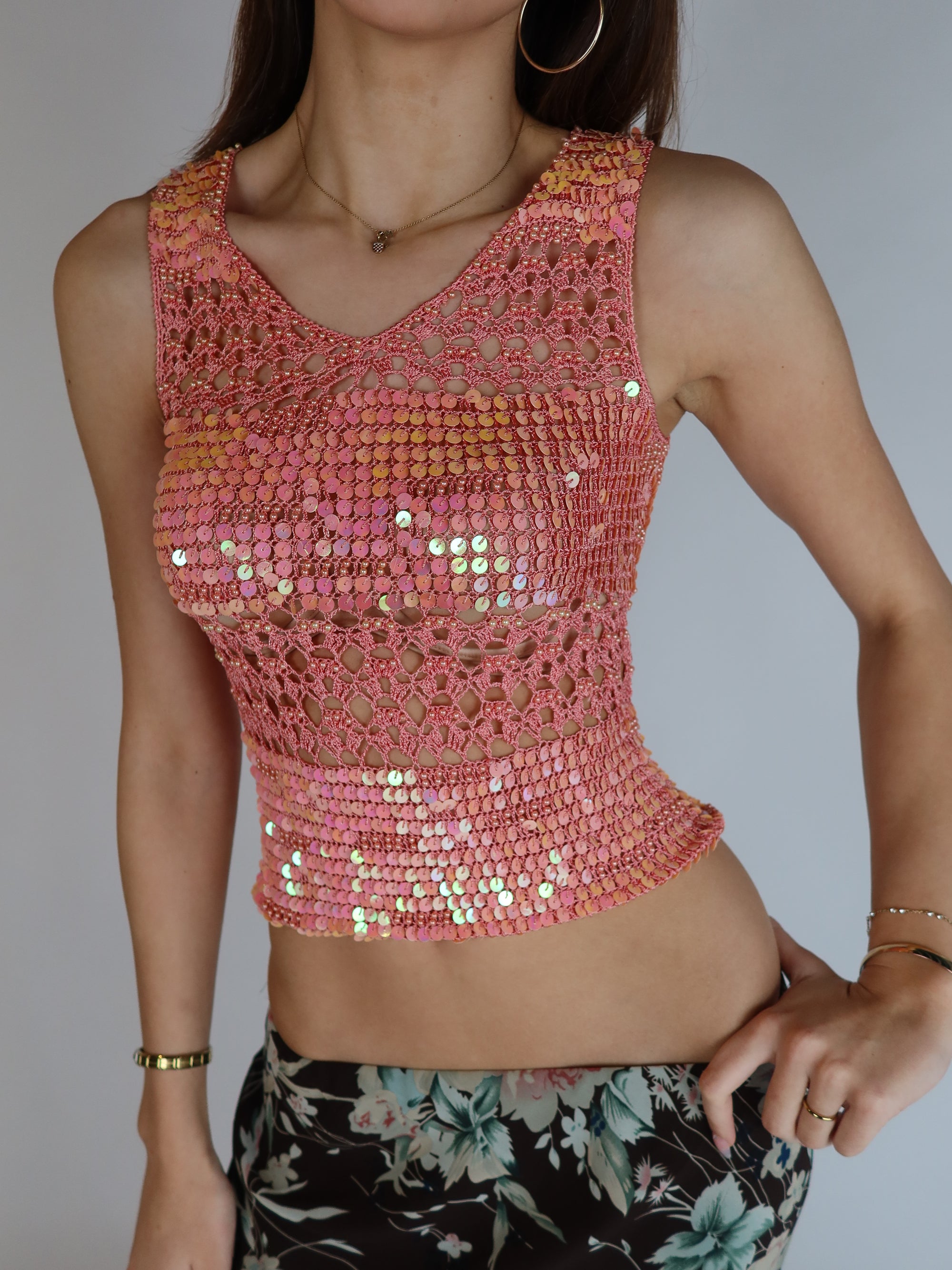 Vintage Y2K pink sequin crochet tank top featuring iridescent embellishments, open-knit construction, sleeveless silhouette, and fairycore-inspired styling.