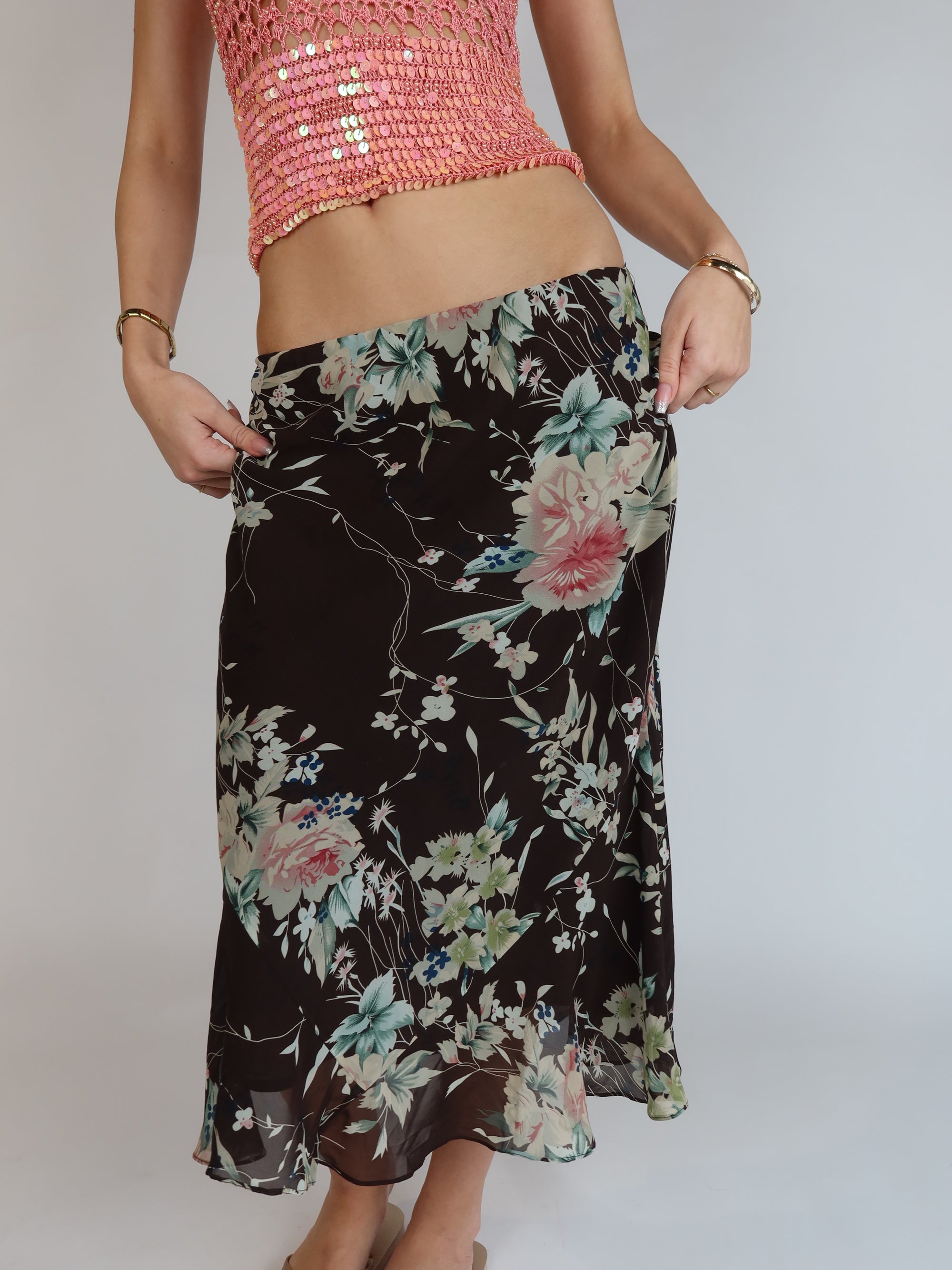 Vintage Y2K black floral mesh midi skirt featuring a pastel floral print, low-rise silhouette, lightweight sheer overlay, and flowy romantic design.