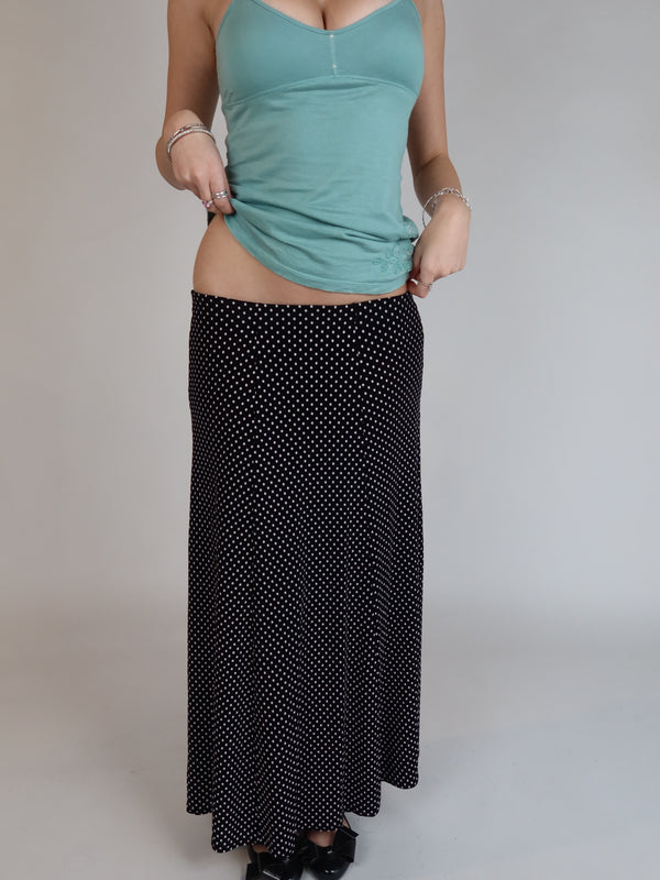 Vintage Y2K black polka dot maxi skirt with a low-rise silhouette, flowing fit, and white micro dot print.