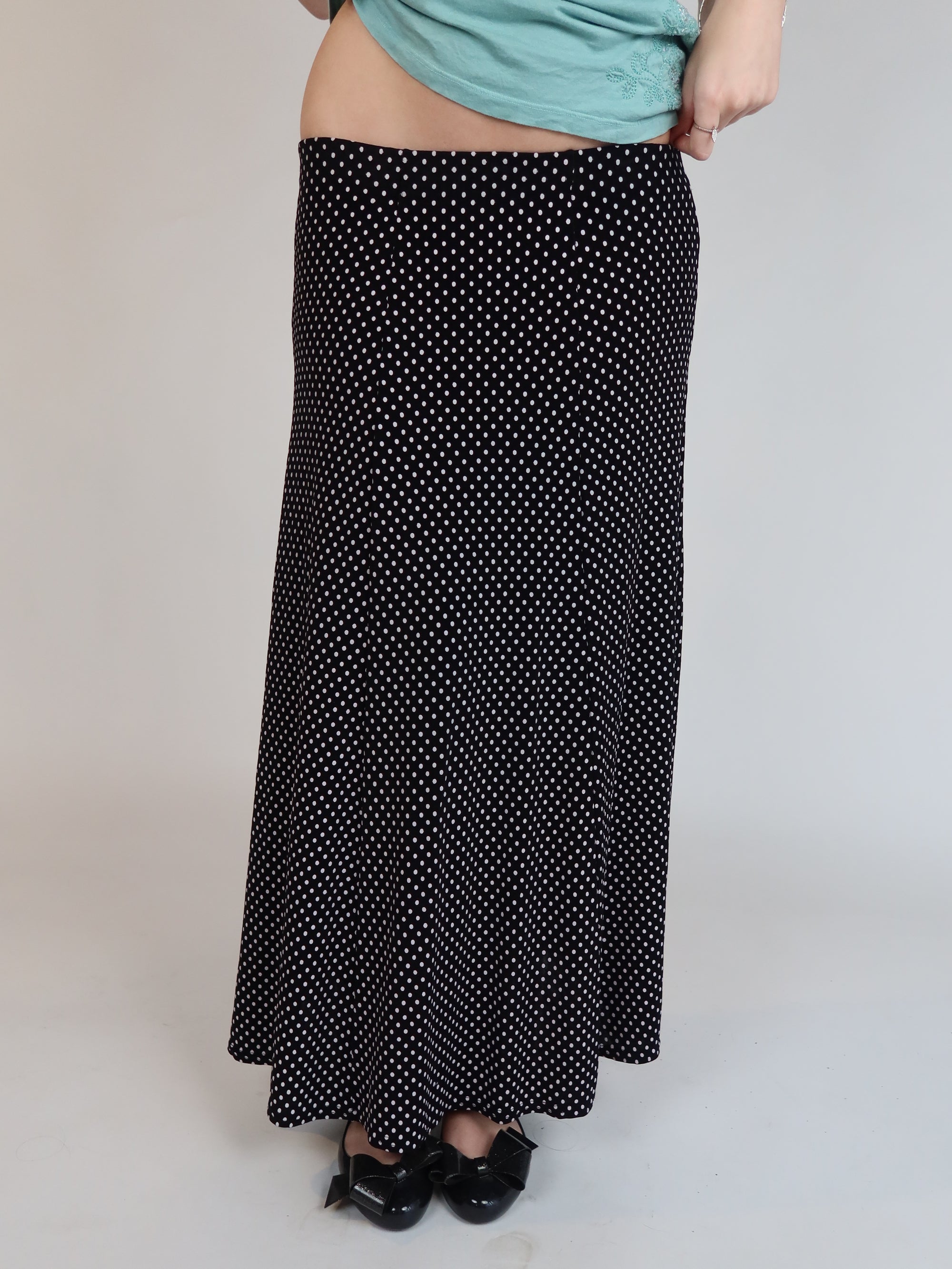 Vintage Y2K black polka dot maxi skirt with a low-rise silhouette, flowing fit, and white micro dot print.