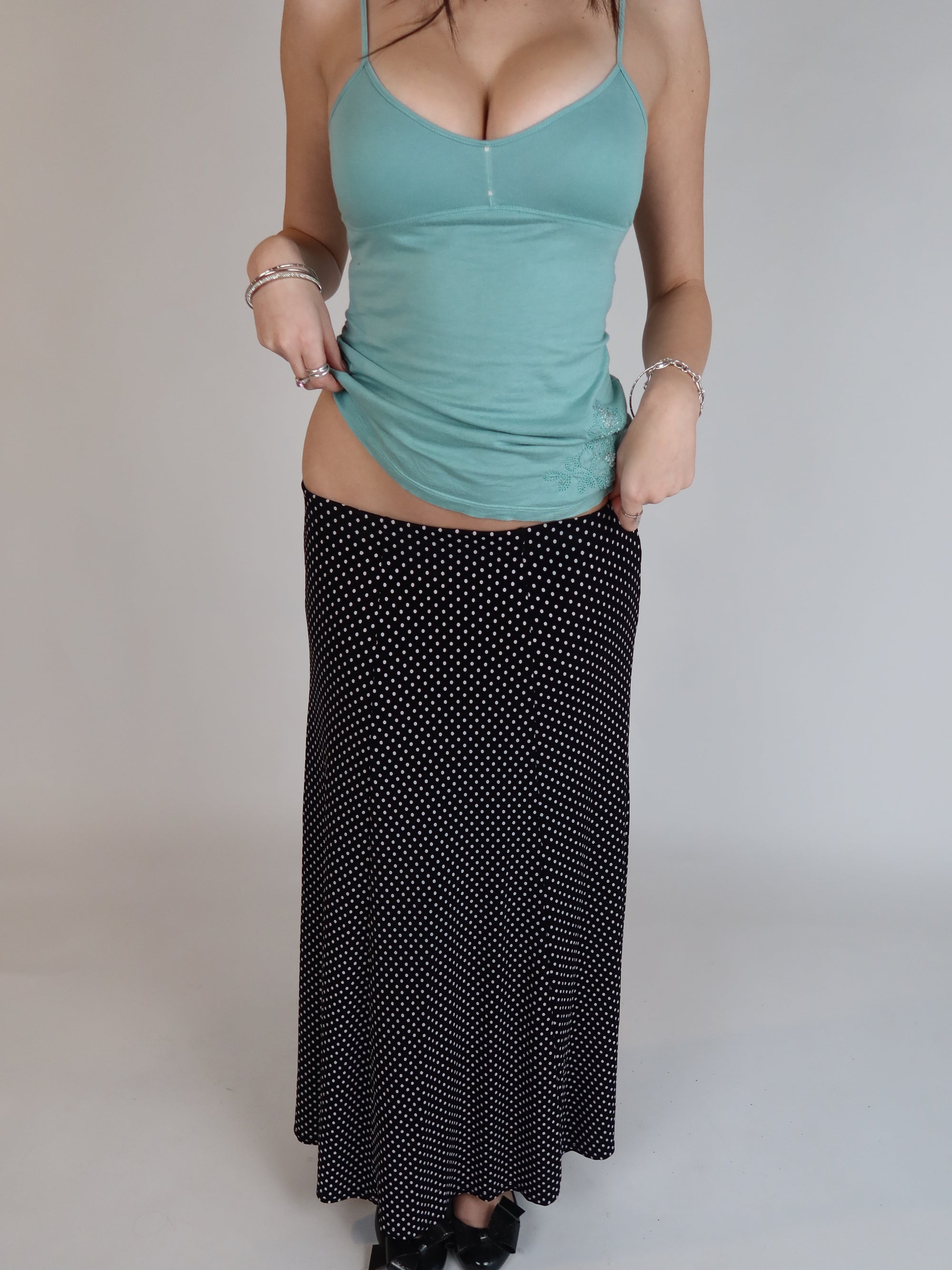 Vintage Y2K black polka dot maxi skirt with a low-rise silhouette, flowing fit, and white micro dot print.