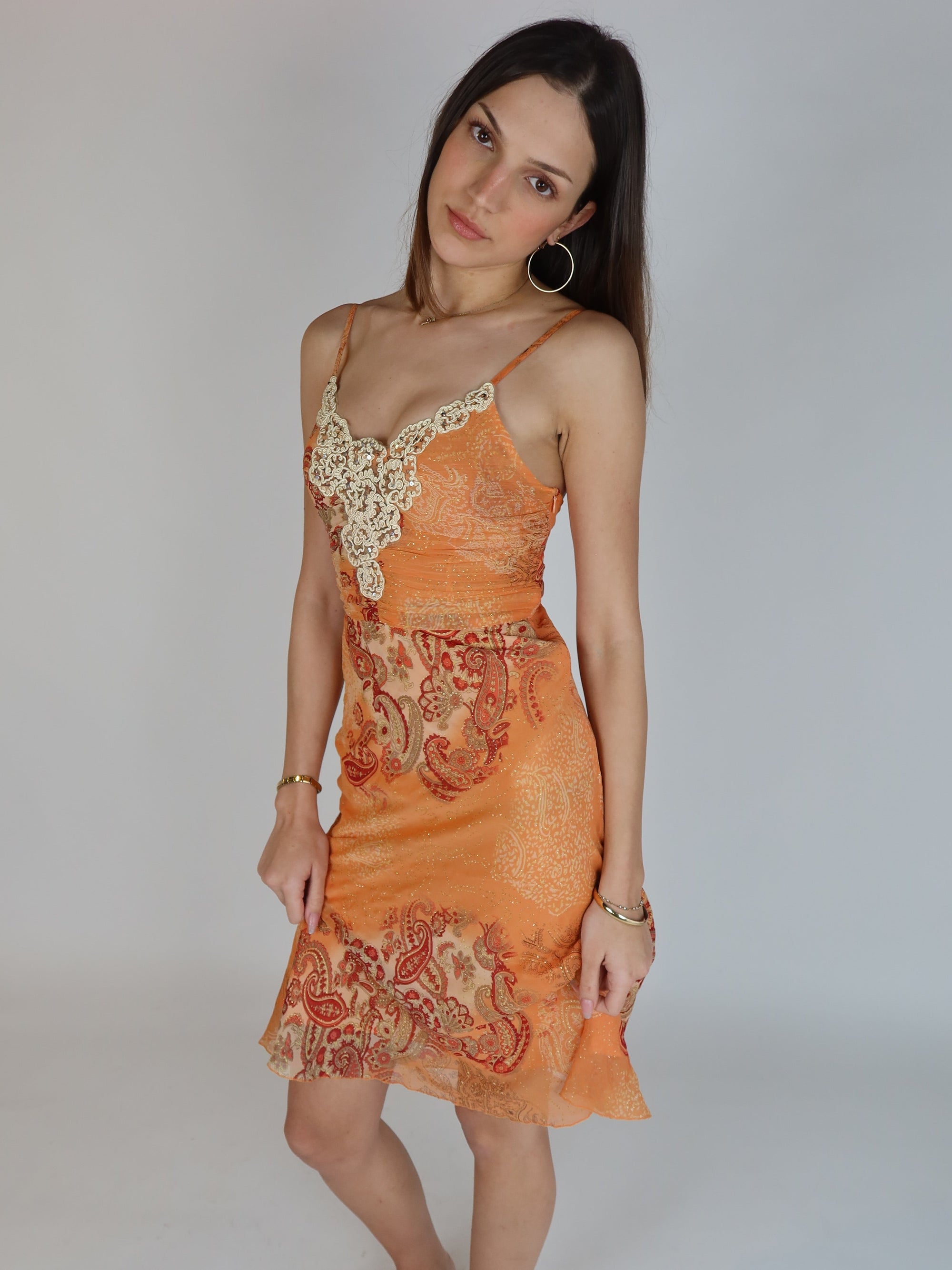 Vintage Y2K orange paisley slip dress with cream lace appliqué neckline, spaghetti straps, subtle shimmer details, and midi-length silhouette.