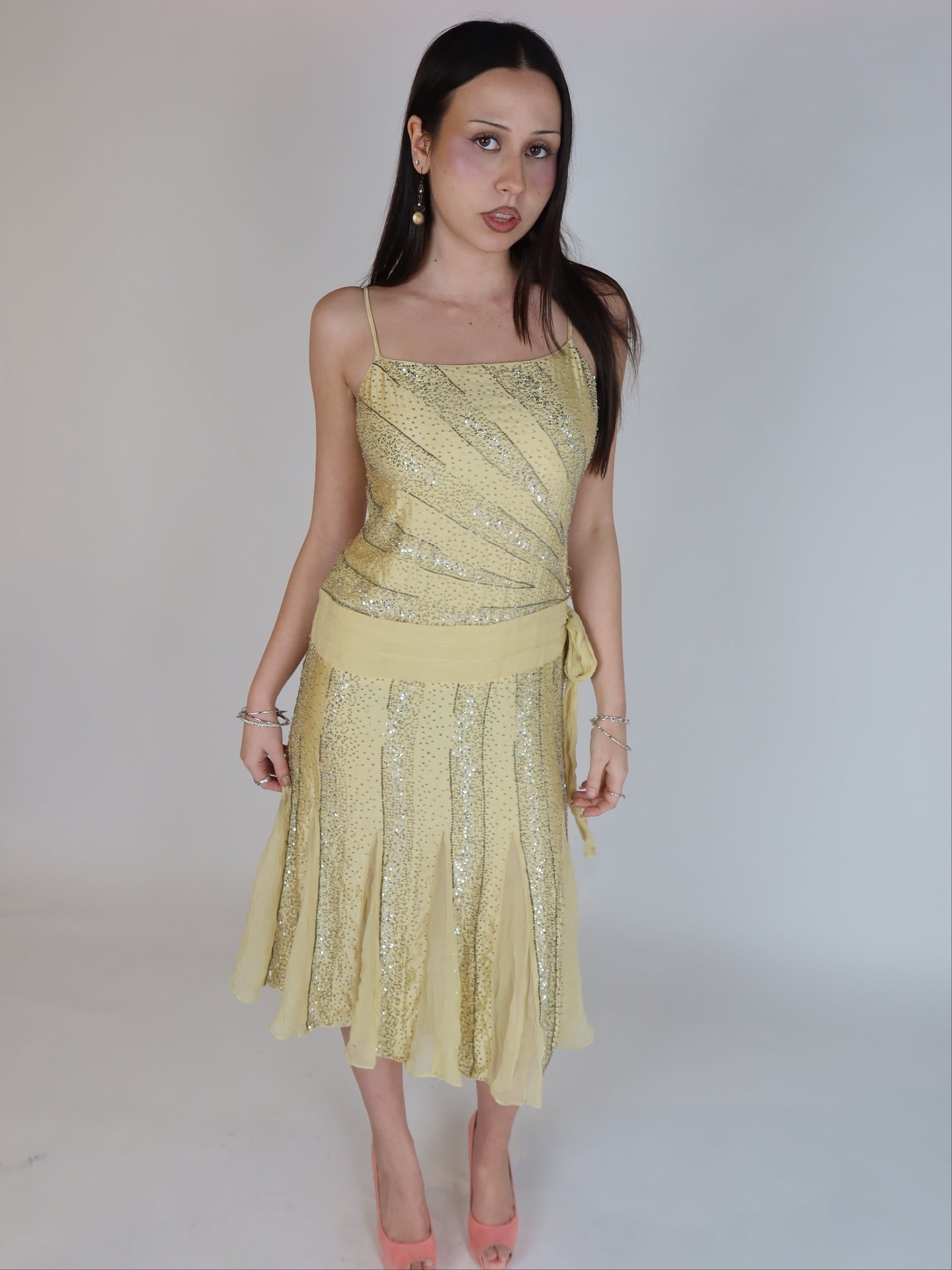 Vintage Y2K 100% silk beaded evening dress with intricate silver embellishments, spaghetti straps, matching waist tie, and handkerchief hem skirt.