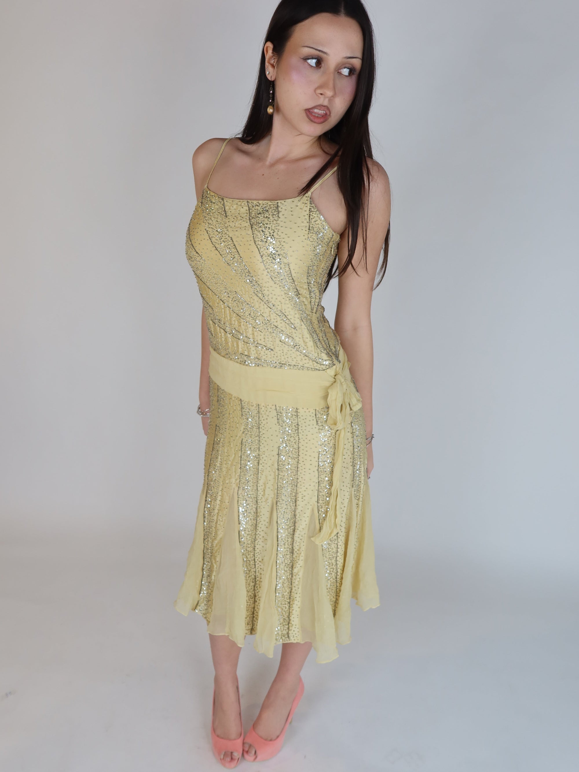 Vintage Y2K 100% silk beaded evening dress with intricate silver embellishments, spaghetti straps, matching waist tie, and handkerchief hem skirt.