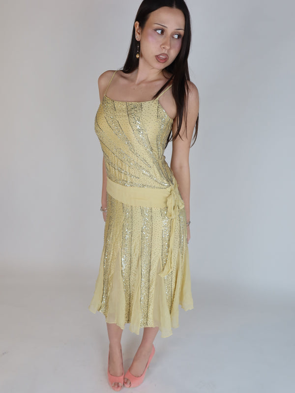 Vintage Y2K 100% silk beaded evening dress with intricate silver embellishments, spaghetti straps, matching waist tie, and handkerchief hem skirt.