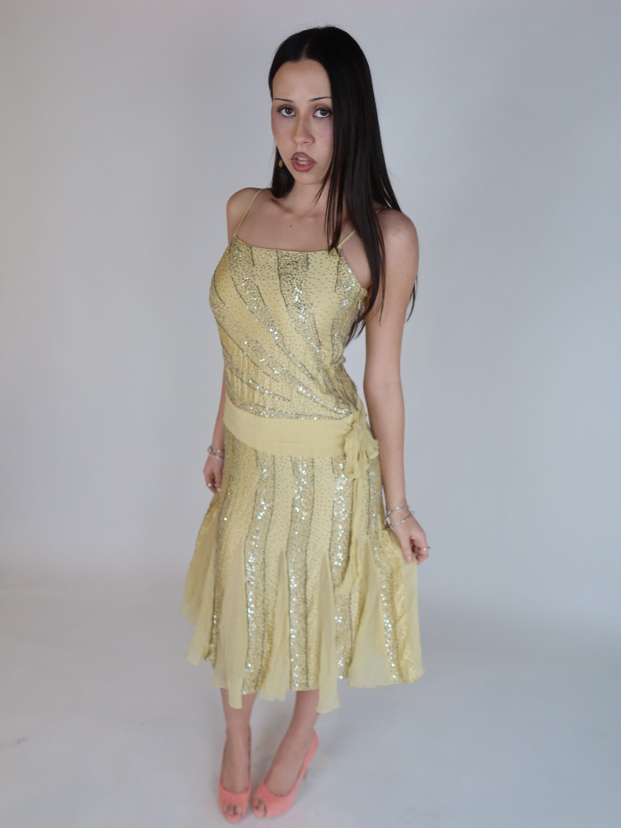 Vintage Y2K 100% silk beaded evening dress with intricate silver embellishments, spaghetti straps, matching waist tie, and handkerchief hem skirt.