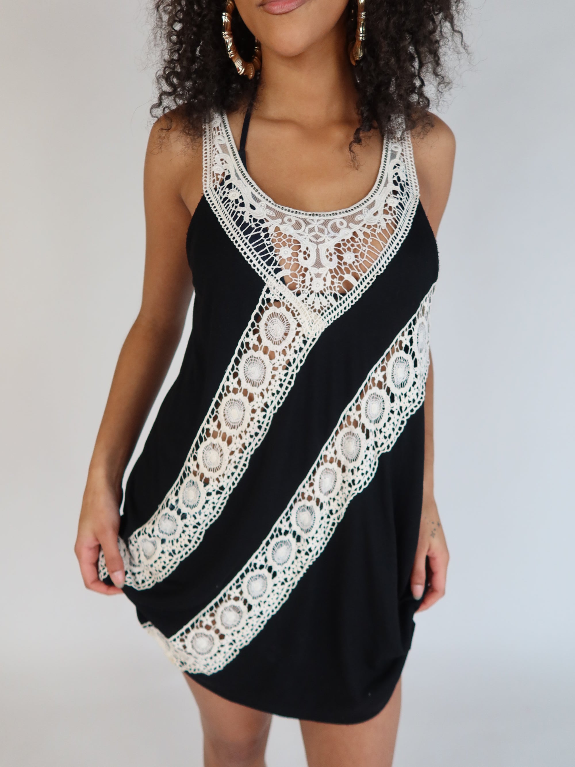 Vintage Y2K black halter mini dress with intricate ivory crochet lace detailing and bohemian-inspired silhouette.