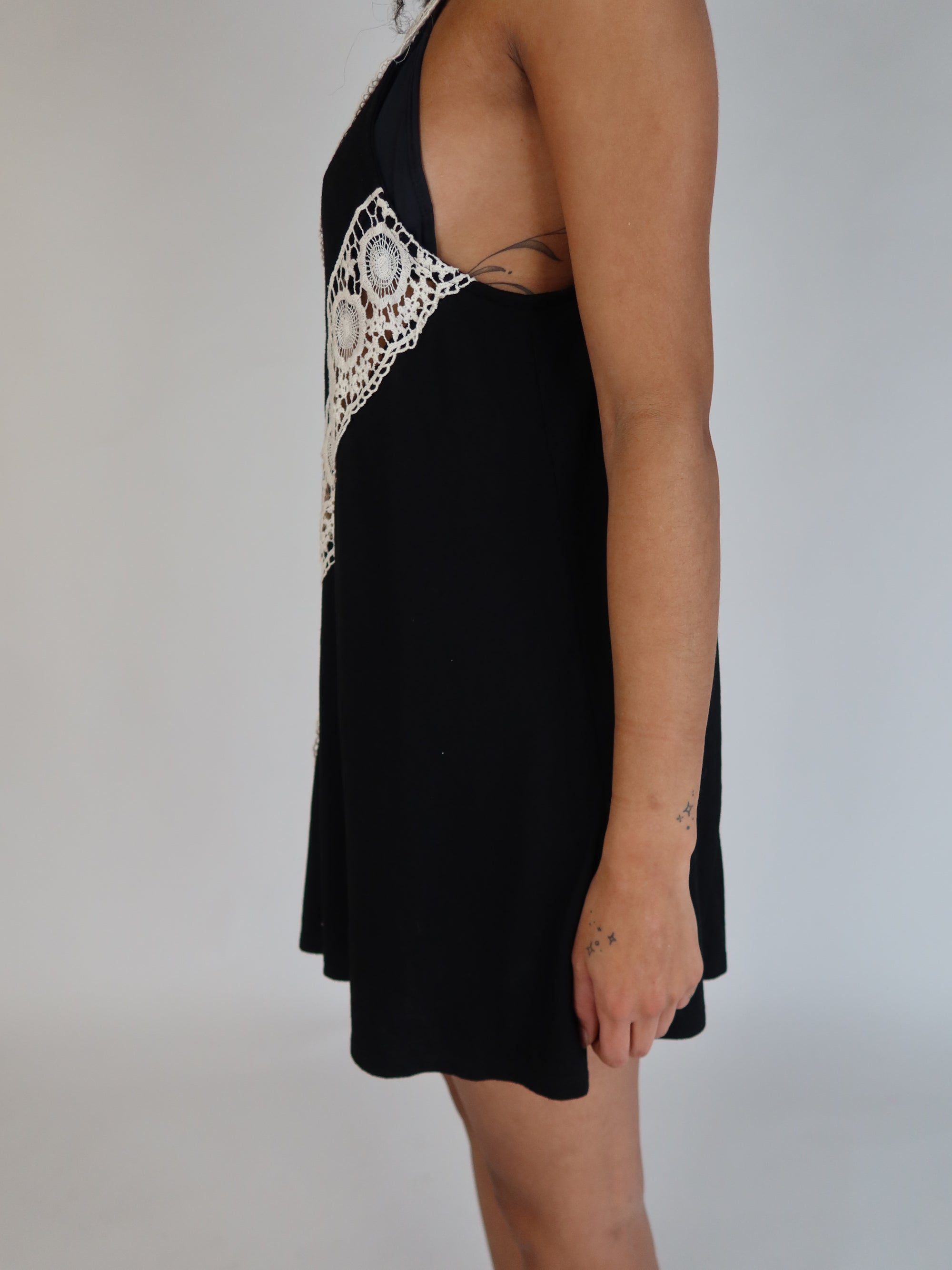 Vintage Y2K black halter mini dress with intricate ivory crochet lace detailing and bohemian-inspired silhouette.