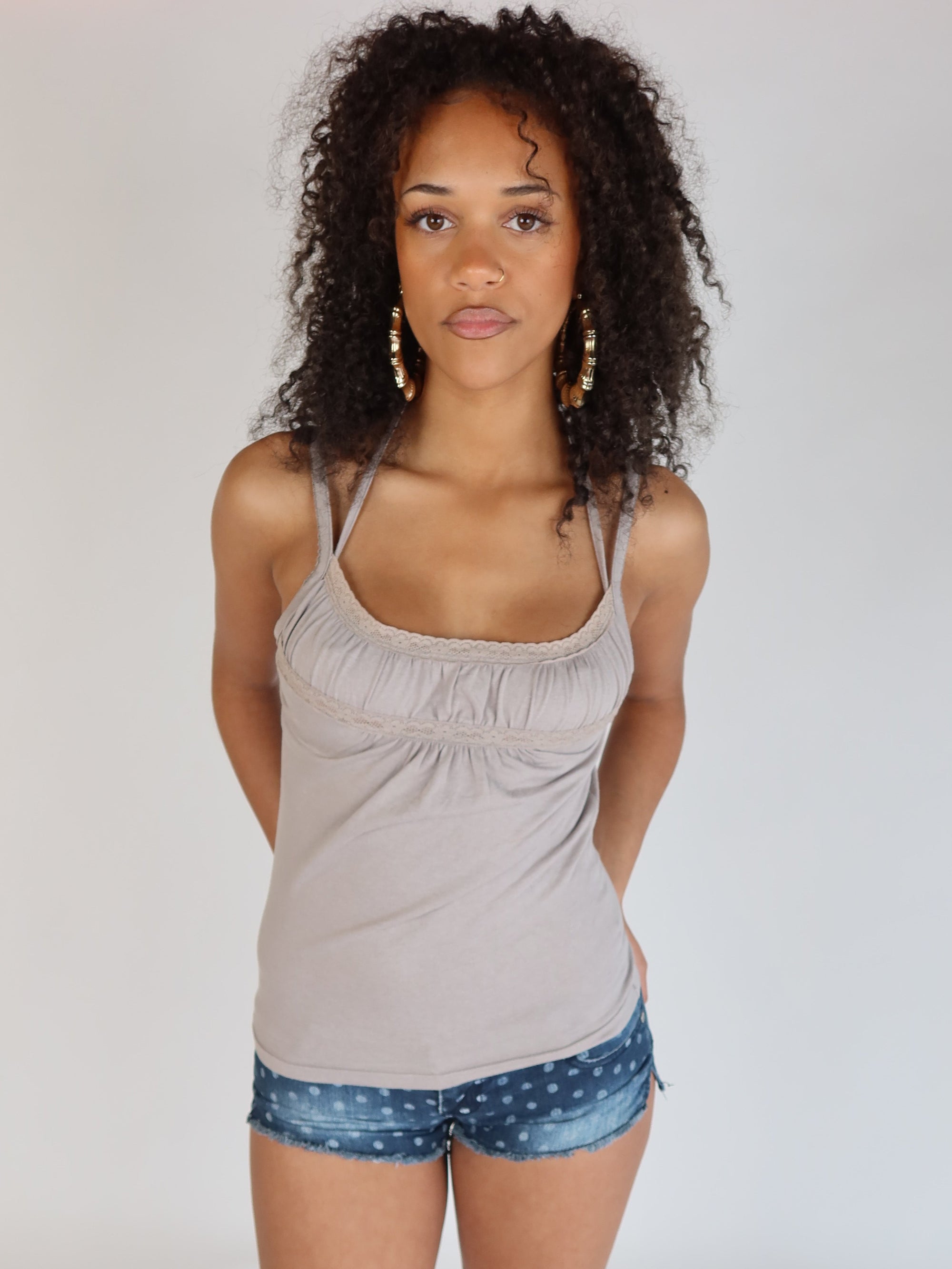 Women's taupe camisole top with spaghetti straps, lace trim, scoop neckline, and gathered empire waist.