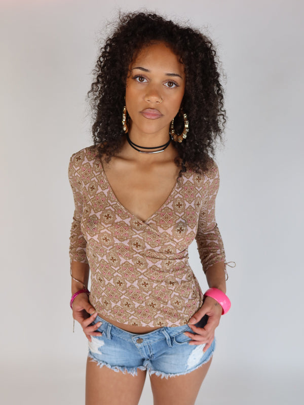 Vintage Y2K pink and brown geometric print mesh wrap top with long sleeves, V-neckline, and adjustable tie sleeve details.