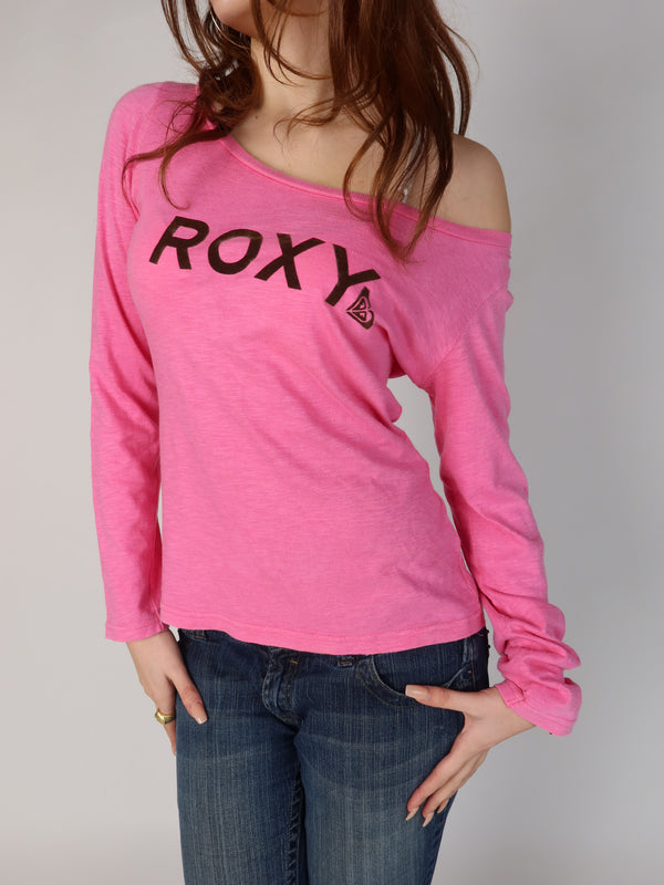 vintage Y2K Roxy bubblegum pink long sleeve top with an off-shoulder neckline, brown flocked logo text on front and back, shown from front and back views with low-rise jeans.