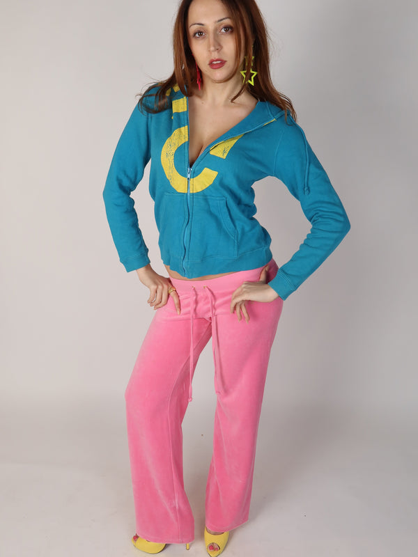 Authentic vintage Y2K long-sleeve zip-up hoodie in teal blue featuring a large distressed yellow graphic print across the chest and on the back hip, shown from front, close-up, and back views.