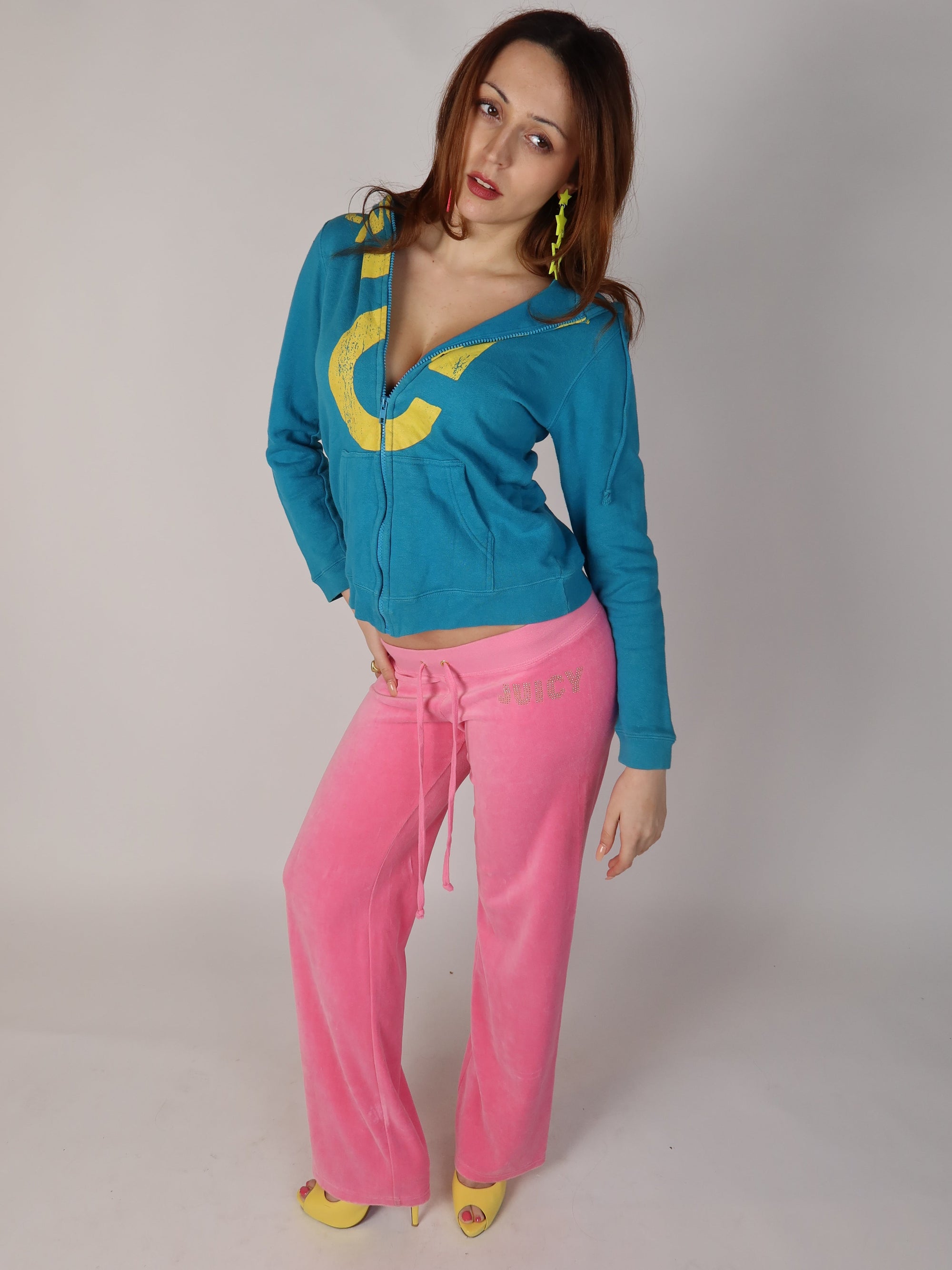 Authentic vintage Y2K long-sleeve zip-up hoodie in teal blue featuring a large distressed yellow graphic print across the chest and on the back hip, shown from front, close-up, and back views.
